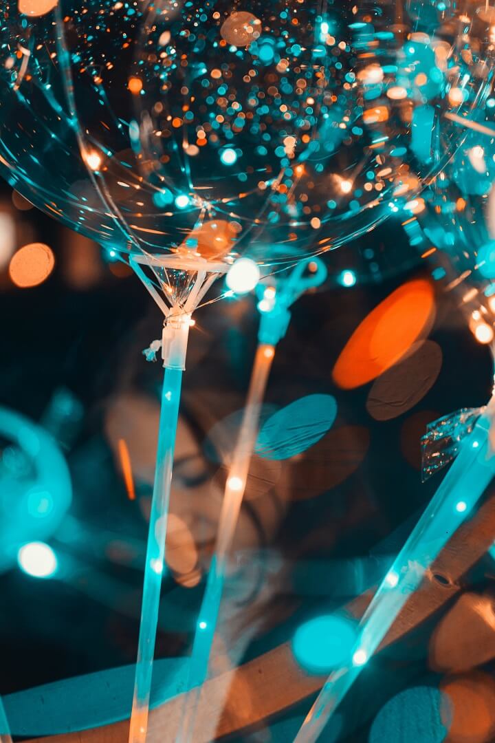 Girl celebrating with glowing balloons